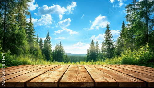 A bright midday sky filled with fluffy clouds overlooks a lush forest, creating a peaceful atmosphere. A wooden platform in the foreground invites closer observation of nature.