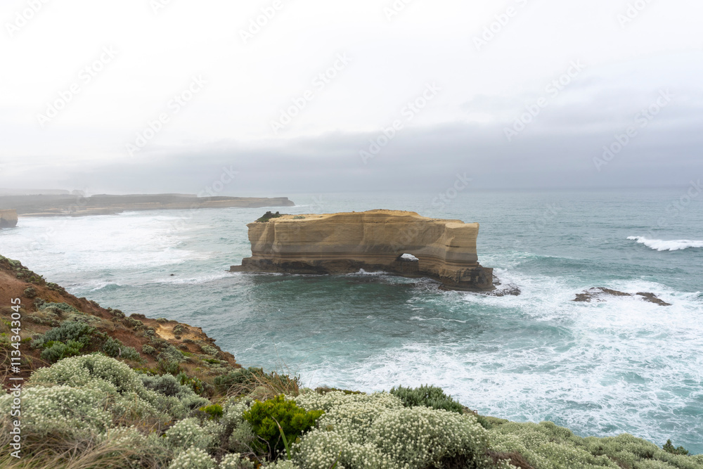 The Bakers Oven so called for the shape of the natural arch in the cliff face. A sea stack on the coast of the Great ocean Road, Australia. The Bakers Oven so called for the shape of the natural arch in the cliff face. A sea stack on the coast of the Great ocean Road, Australia.