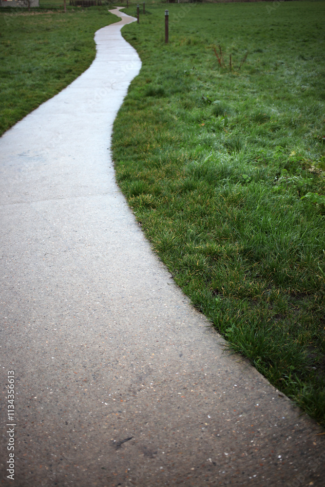 White swirling pedestrian path on grass area - Houdan - Yvelines - France White swirling pedestrian path on grass area - Houdan - Yvelines - France