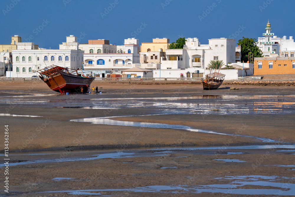 Sur, Oman. Traditional ships Dhow in the lagoon. Travel and summer tourism in Arab countries Sur, Oman. Traditional ships Dhow in the lagoon. Travel and summer tourism in Arab countries