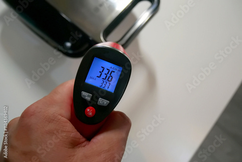 A pyrometer for measuring temperature. Photo of the temperature on the pyrometer