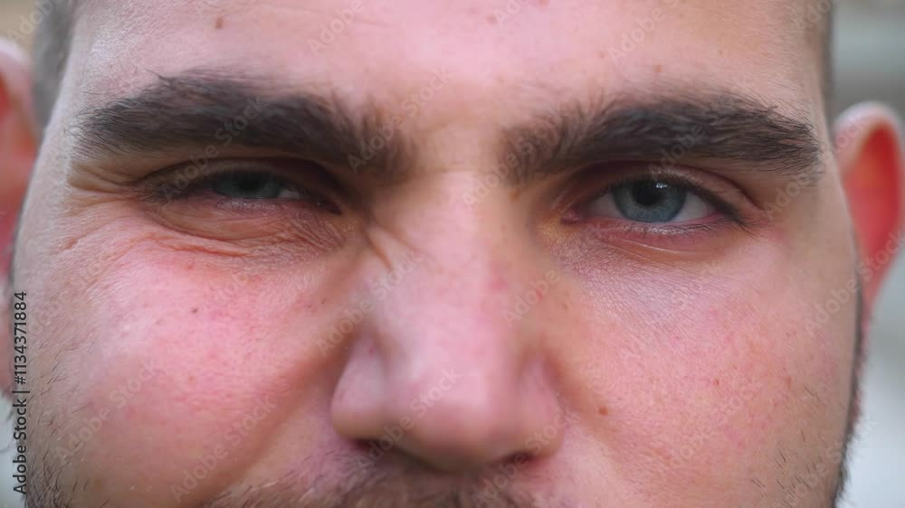 Extreme close-up of a young bald man's blue eyes, highlighting the vividness and detail. Extreme close-up of a young bald man's blue eyes, highlighting the vividness and detail.