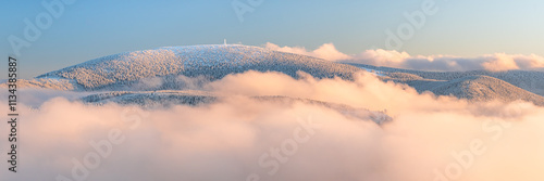Obraz na płótnie Eastern Sudetes, View of snowy mountain range in fog from hiking trail during winter hike in mountains, viewpoint of wide winter landscape in mountains at sunset. w salonie