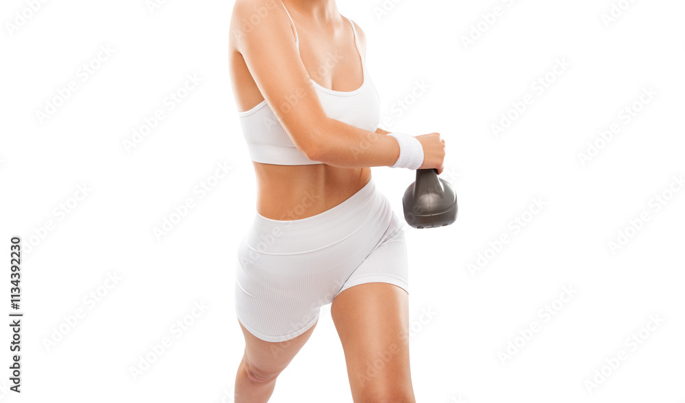 Beautiful attractive girl in white shorts and a top lifts heavy dumbbell while training in the gym. Sports concept, fat burning and a healthy lifestyle Beautiful attractive girl in white shorts and a top lifts heavy dumbbell while training in the gym. Sports concept, fat burning and a healthy lifestyle