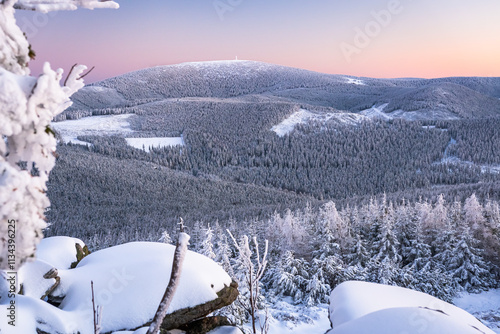 Obraz na płótnie Eastern Sudetes, View of snowy mountain range from hiking trail during winter hike in the mountains, viewpoint of wide winter landscape in the mountains at sunset. w salonie