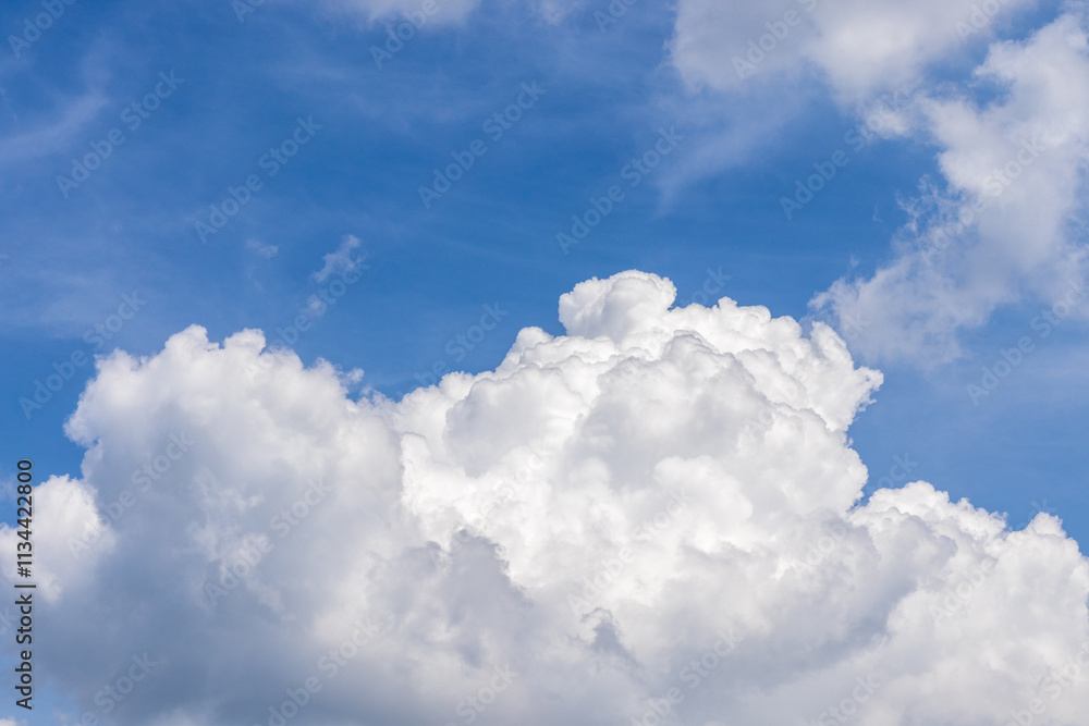 A big white cloud in the blue sky on a beautiful Sunny day. as a background A big white cloud in the blue sky on a beautiful Sunny day. as a background