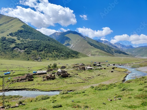 Ancient village in the Truso Valley with mountains and river in the background photo