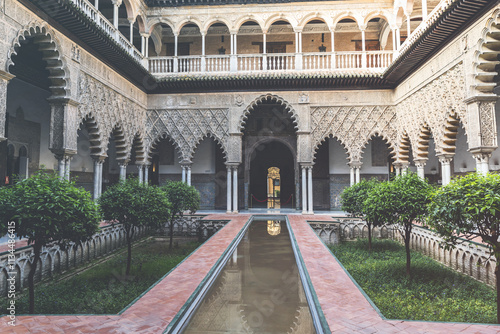 Beautiful formal public garden inside Alcazar Seville palace in summertime in Andalusia