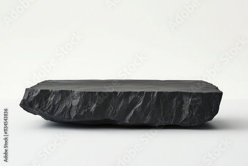 imagine a short, wide black rock plinth that is flat on the surface and raw on the edges photo