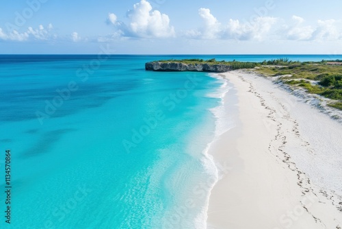 Serene Tropical Beach with Crystal Clear Waters and White Sand Under Beautiful Blue Sky, Perfect for Vacation and Relaxation in a Tropical Paradise Setting