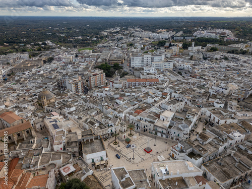 Aerial drone photo of the town square and clock tower in Ceglie Messapica, a city in Puglia southern Italy. photo