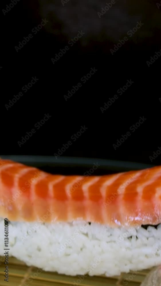 Chef Prepares Salmon Sushi By Using Cling Wrap. Cook Makes Sushi With Delicious Salmon. Food Preparation. Salmon Sushi Preparation At Asian Cuisine Restaurant Kitchen. Japanese Cuisine. Chef Prepares Salmon Sushi By Using Cling Wrap. Cook Makes Sushi With Delicious Salmon. Food Preparation. Salmon Sushi Preparation At Asian Cuisine Restaurant Kitchen. Japanese Cuisine.