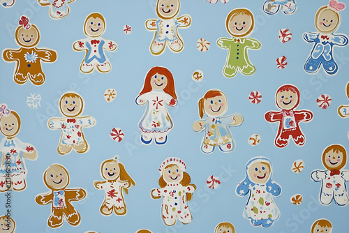 A whimsical pattern featuring colorful gingerbread figures on a light blue background. photo