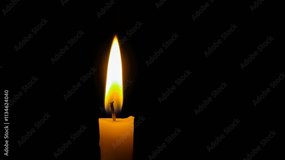 Single burning candle flame against a dark background Single burning candle flame against a dark background