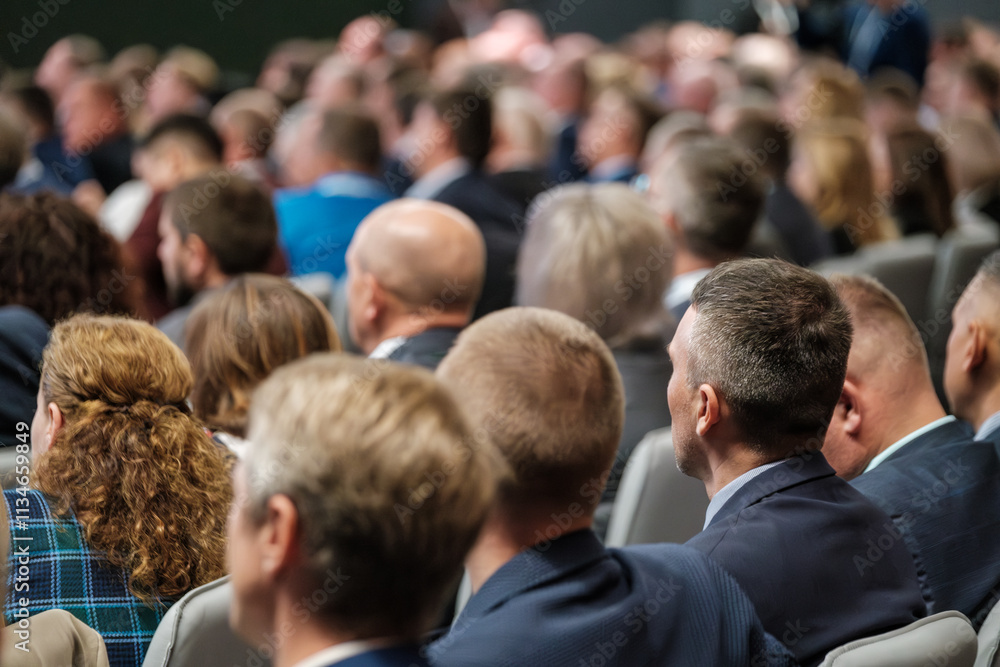Crowded gathering of professionals attending a conference or meeting in a corporate setting Crowded gathering of professionals attending a conference or meeting in a corporate setting