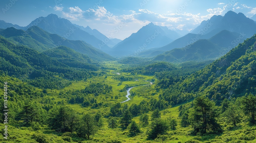Fototapeta premium A serene valley surrounded by mountains, featuring lush greenery and a winding river.
