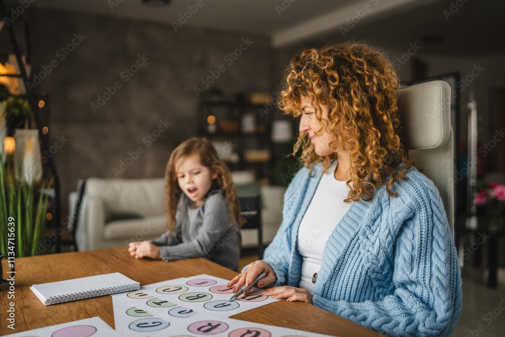 little girl and speech therapist practice together at home little girl and speech therapist practice together at home