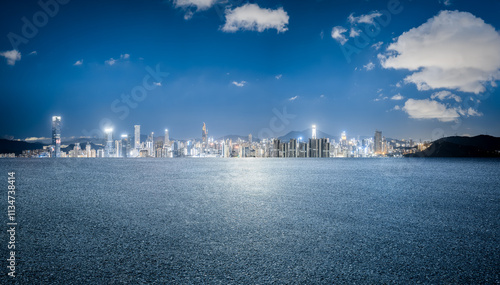 Empty asphalt road and cityscape with skyline in modern city at night