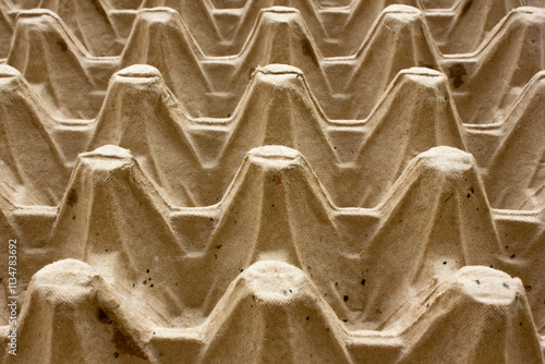 Biodegradable brown paper packaging with repeating pattern for fragile hen eggs. photo