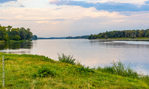 Vistula river landscape at summer early evening with riverside with wild beaches and embankment near Czerwinsk village in Mazovia region of Poland