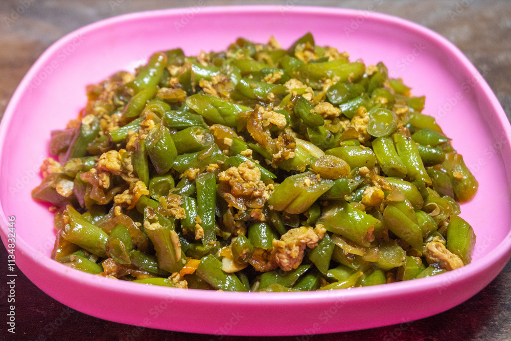 Stir-fried green beans mixed with chicken eggs served on a plate Stir-fried green beans mixed with chicken eggs served on a plate