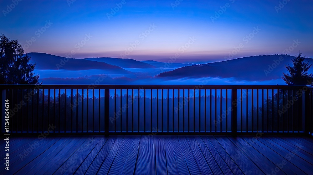 Obraz premium A wide-angle view of a wooden deck with a backdrop of mist-covered mountains and untouched wilderness.