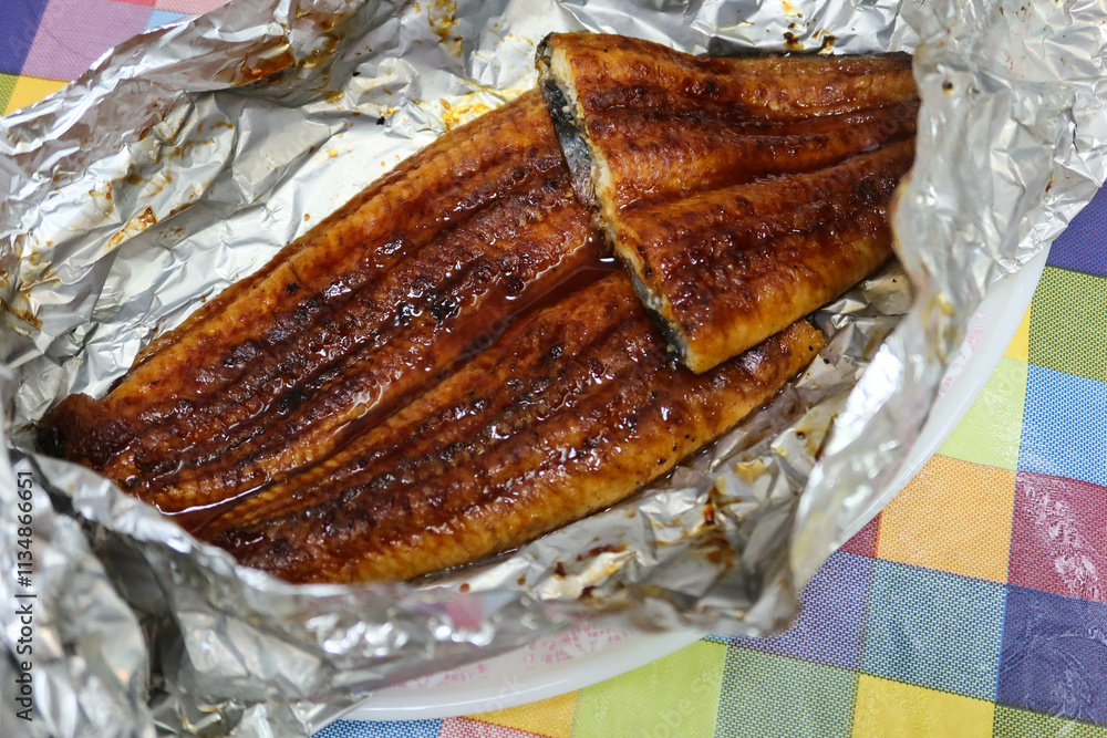 close up of homemade Japanese grilled sauce eel fish in the aluminium foil close up of homemade Japanese grilled sauce eel fish in the aluminium foil