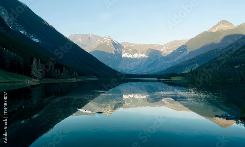 Wallpaper Mural In the morning light a serene landscape unfolds, where the tranquil lake reflects the majestic mountains and their enchanting surroundings Torontodigital.ca