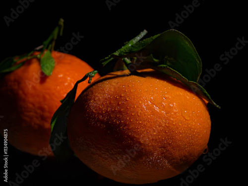 Clementines agaunst a black background