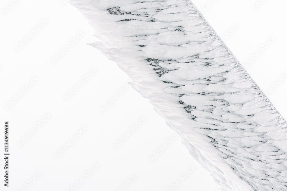 Winter landscape, white frost on a wooden beam of elongated shape from the blowing wind.