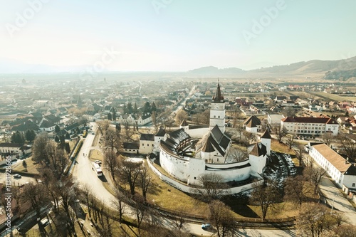 Expansive vistas capture the historic Rasnov citadel nestled amidst charming villages and rolling hills, a remarkable blend of nature and ancient architecture in Brasov, Romania