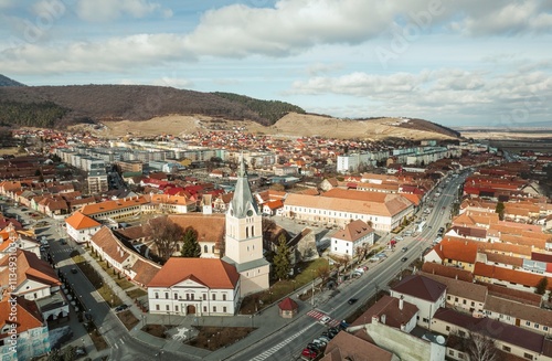 Breathtaking aerial perspective reveals the beauty of Piatra Craiului, the historical Rasnov fortress, and the serene village of Plaiul Foii, all nestled in nature’s embrace in Brasov, Romania photo