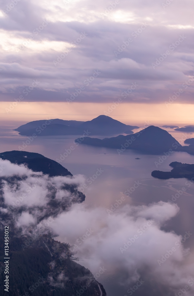 Fototapeta premium Scenic Aerial View of Misty Mountains and Islands at Sunrise