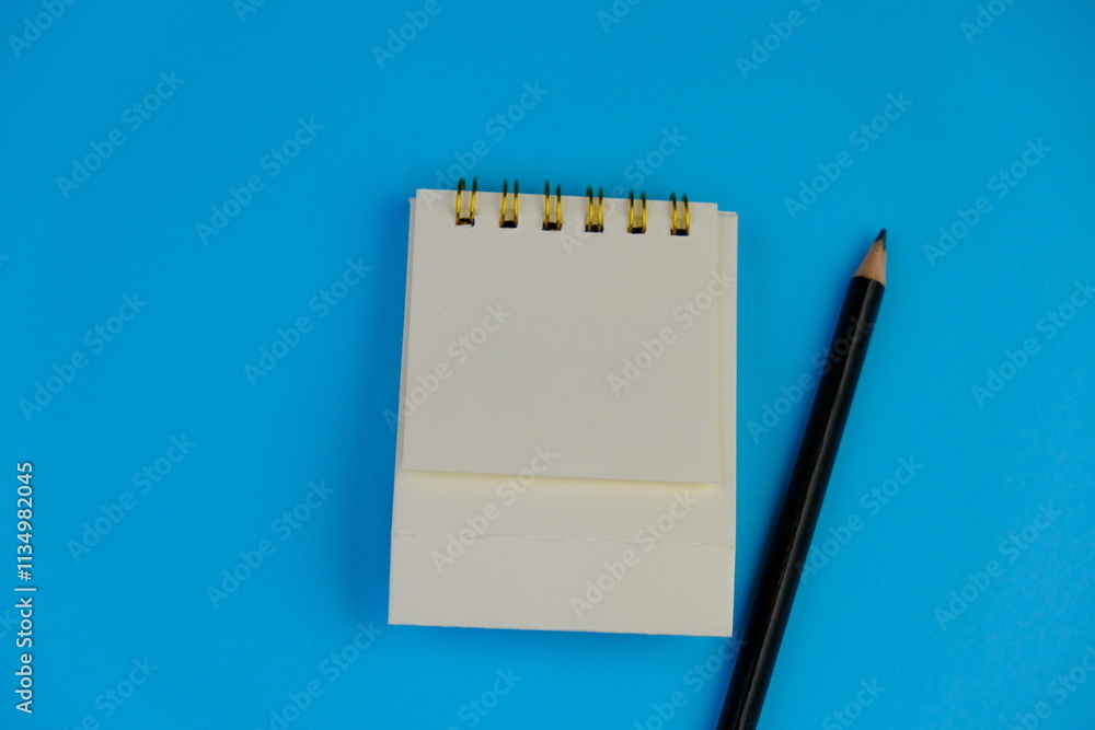 flat lay of a blank note book for text space. Educational concept with text space on yellow background. surrounded by yellow tools such as pen, alarm clock and calculator flat lay of a blank note book for text space. Educational concept with text space on yellow background. surrounded by yellow tools such as pen, alarm clock and calculator