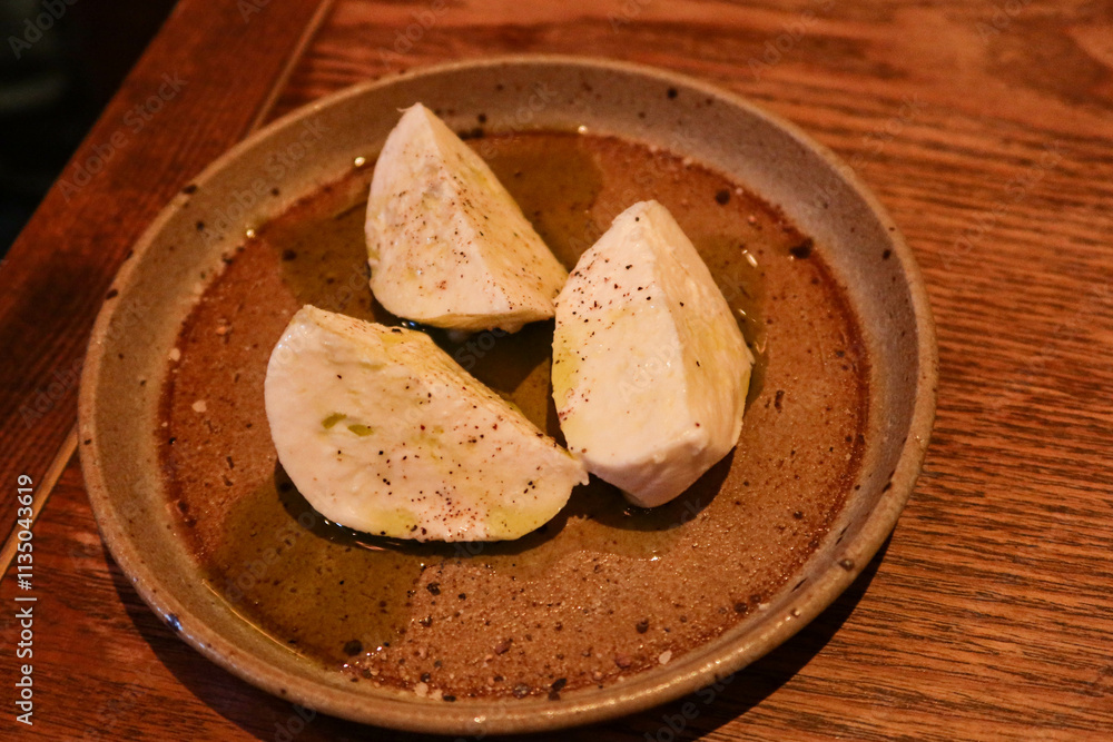 close up of mozzarella cheese in three quarter on a plate with copy space close up of mozzarella cheese in three quarter on a plate with copy space