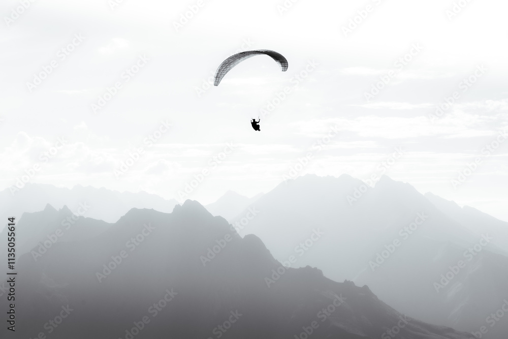 A paraglider flies into the heart of the French Pyrenees mountains A paraglider flies into the heart of the French Pyrenees mountains