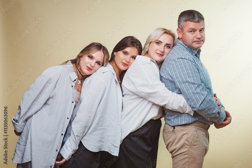Four individuals pose together, showcasing friendship and connection against a plain background Four individuals pose together, showcasing friendship and connection against a plain background