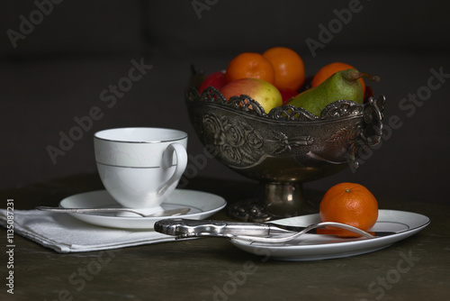 Still life: ceramic set of dishes and fruits.