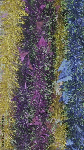 christmas tree decorations and colorful feathers background