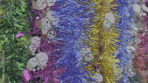 christmas tree decorations and colorful feathers background
