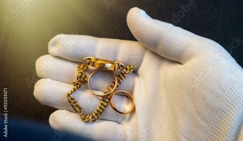 Purchase of gold jewelry.A white-gloved hand holds jewelry rings.Pawnshop.