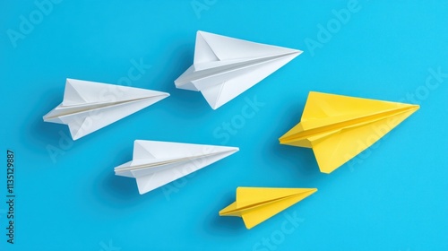 Several origami paper airplanes, one yellow, stand out from the rest on a bright blue background.