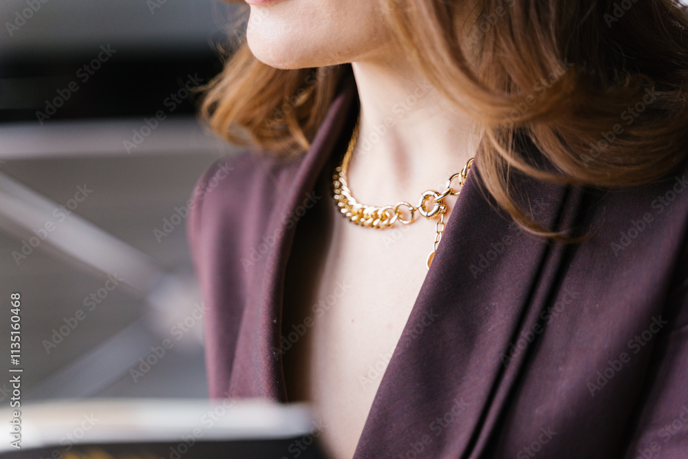 An Elegant Woman Wearing Gold Jewelry While Adorning a Truly Sophisticated Outfit
