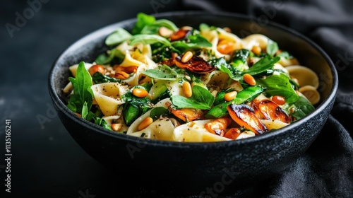 A visually appealing dish of fresh pasta salad mixed with vibrant greens, roasted vegetables, and pine nuts, offering a healthy and flavorful culinary experience.