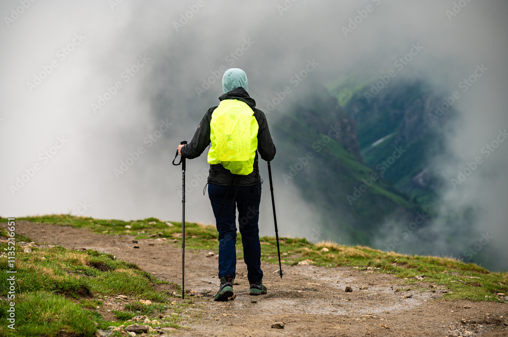 Obraz premium Achievement of female hiker standing with enjoying the Mont Blanc mountain range view during trail in Tour du Mont Blanc, Alps, 