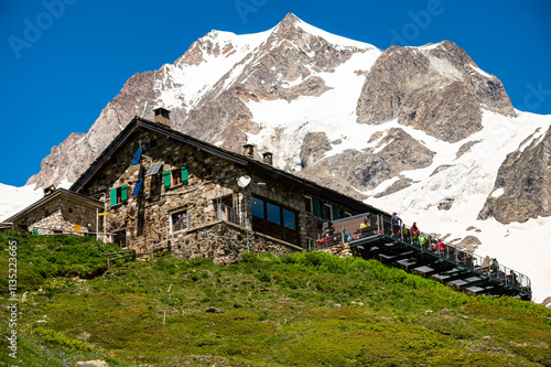 Aosta Valley, Italy The Elisabetta Hut refuge and restaurant terrace, on the background of the Mont Blanc mountain
