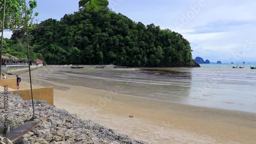 Beach promenade with tropical trees walkway Noppharat Thara Beach Thailand. photo