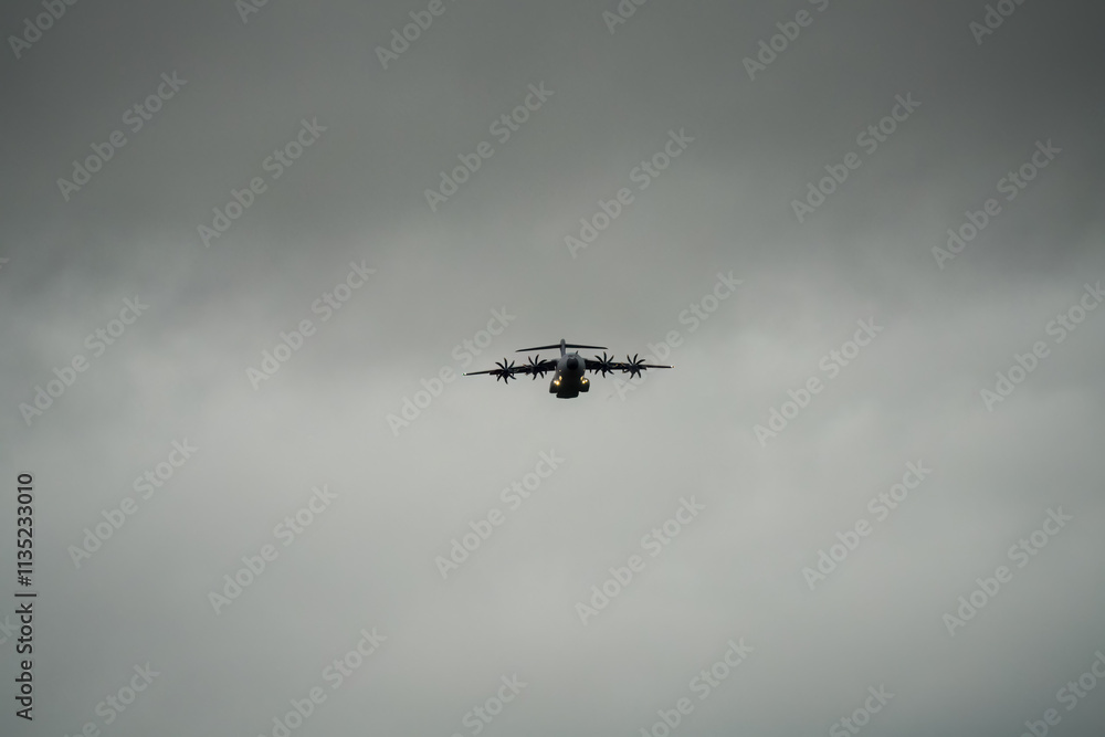 transport plane flying away from a low-level cargo parachute drop exercise transport plane flying away from a low-level cargo parachute drop exercise