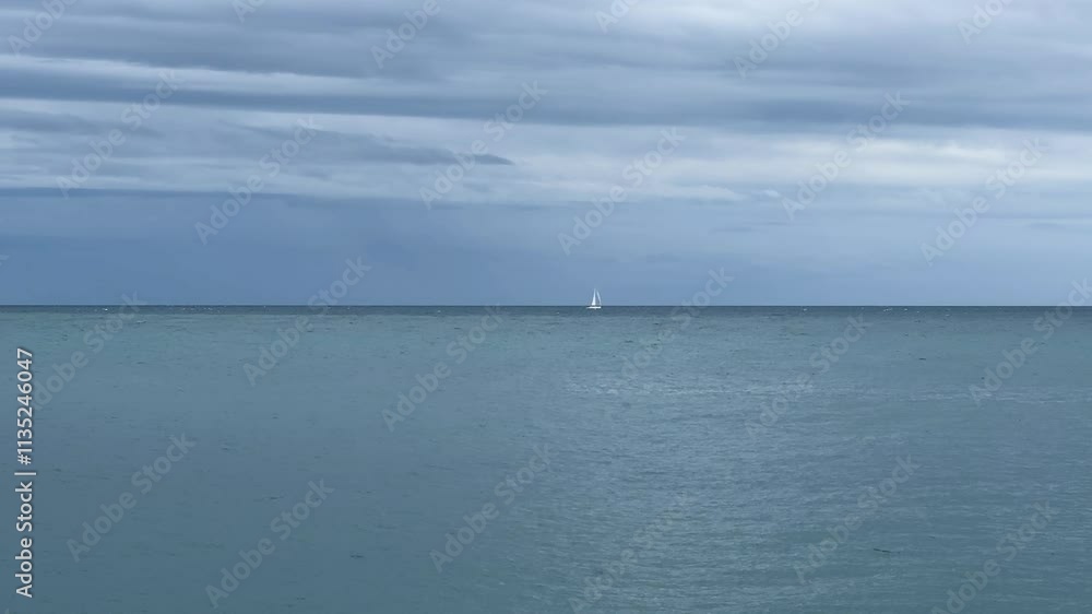 Sea water surface with distant sailing yacht on a horizon Sea water surface with distant sailing yacht on a horizon