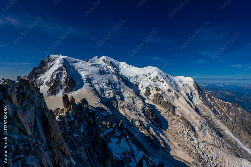 Obraz premium Mont Blanc, Monte Bianco mountain summit in the Alps. The highest mountain in Europe. Snow and glacier covered high altitude snow mountain in the Alps. The top of Montblanc Chamonix valley landscape